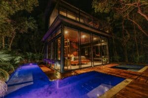 tiny house sijilha surrounded by a moat pool in the jungle